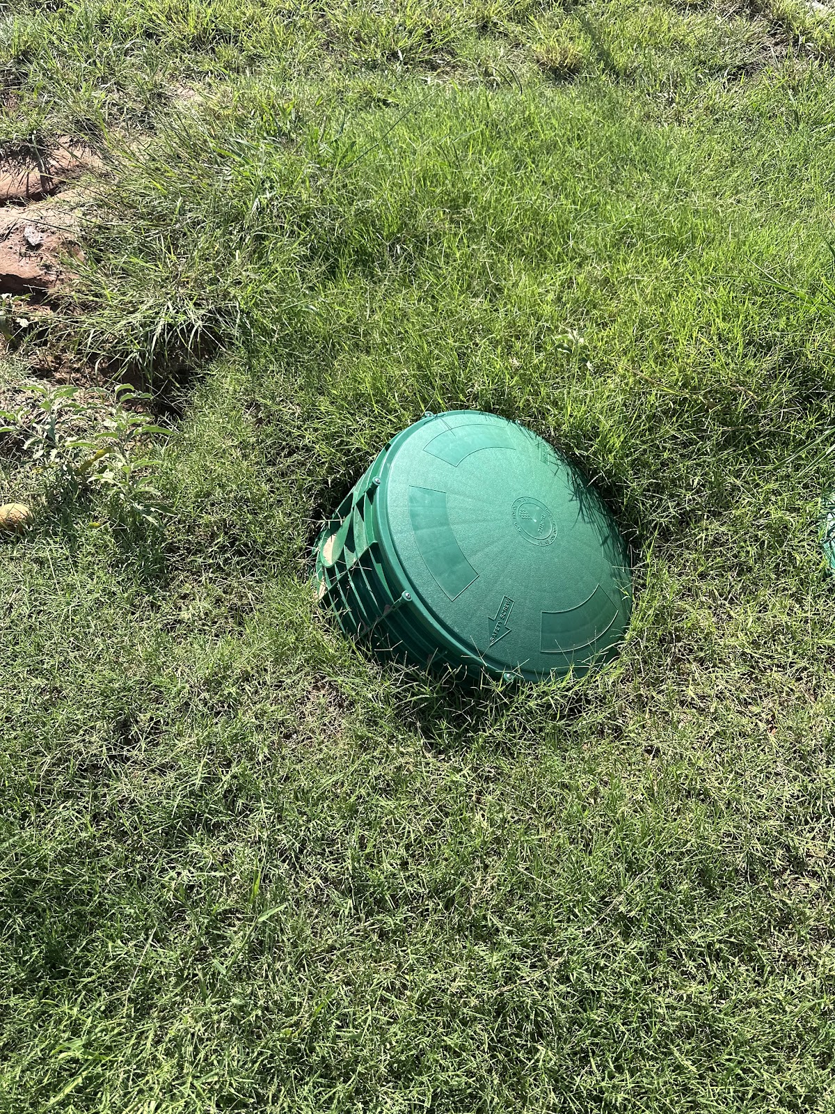 Septic tank access lid installed in a customer's lawn by Monty's