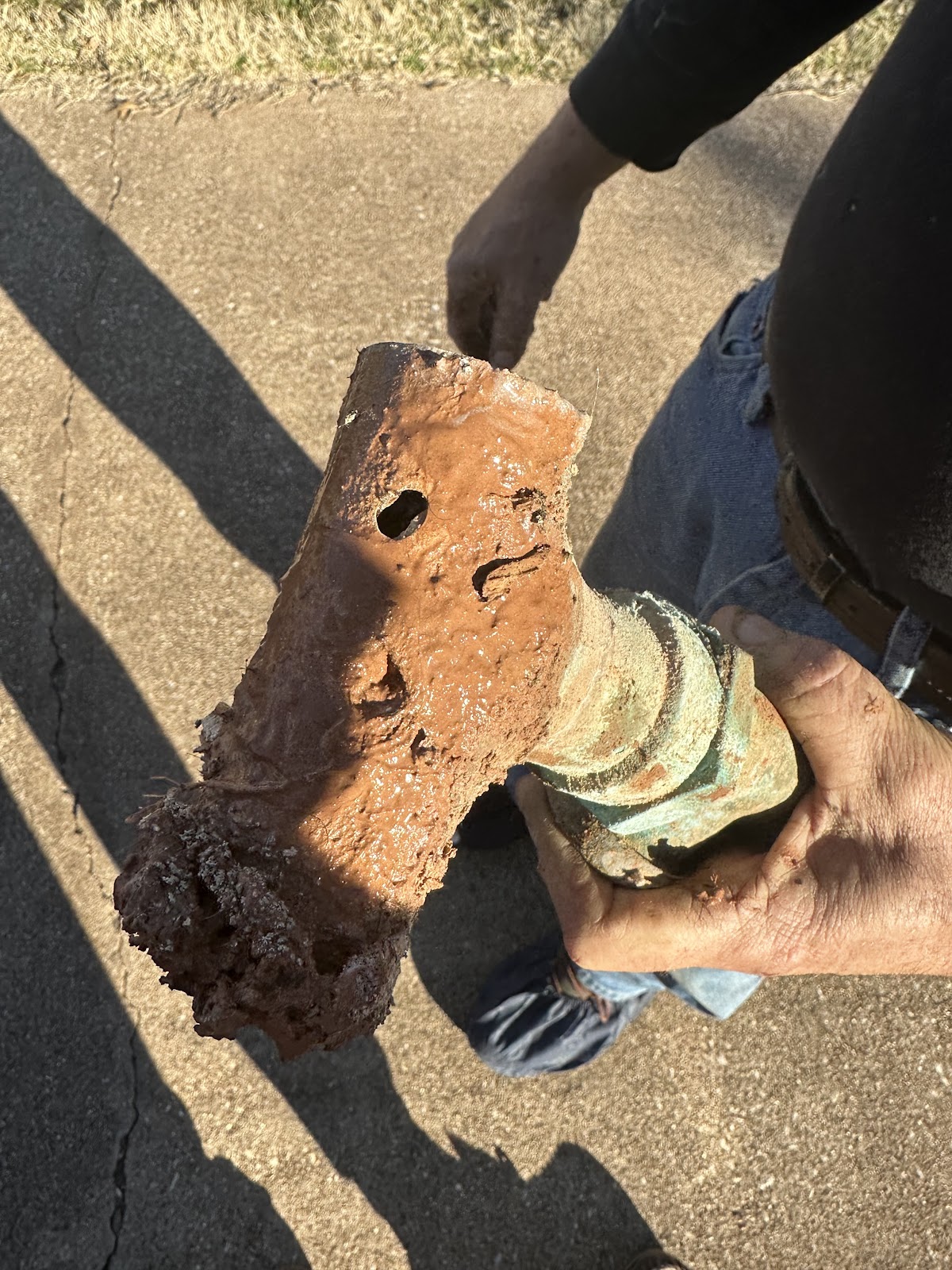 Monty's technician with a corroded pipe pulled from a customer job